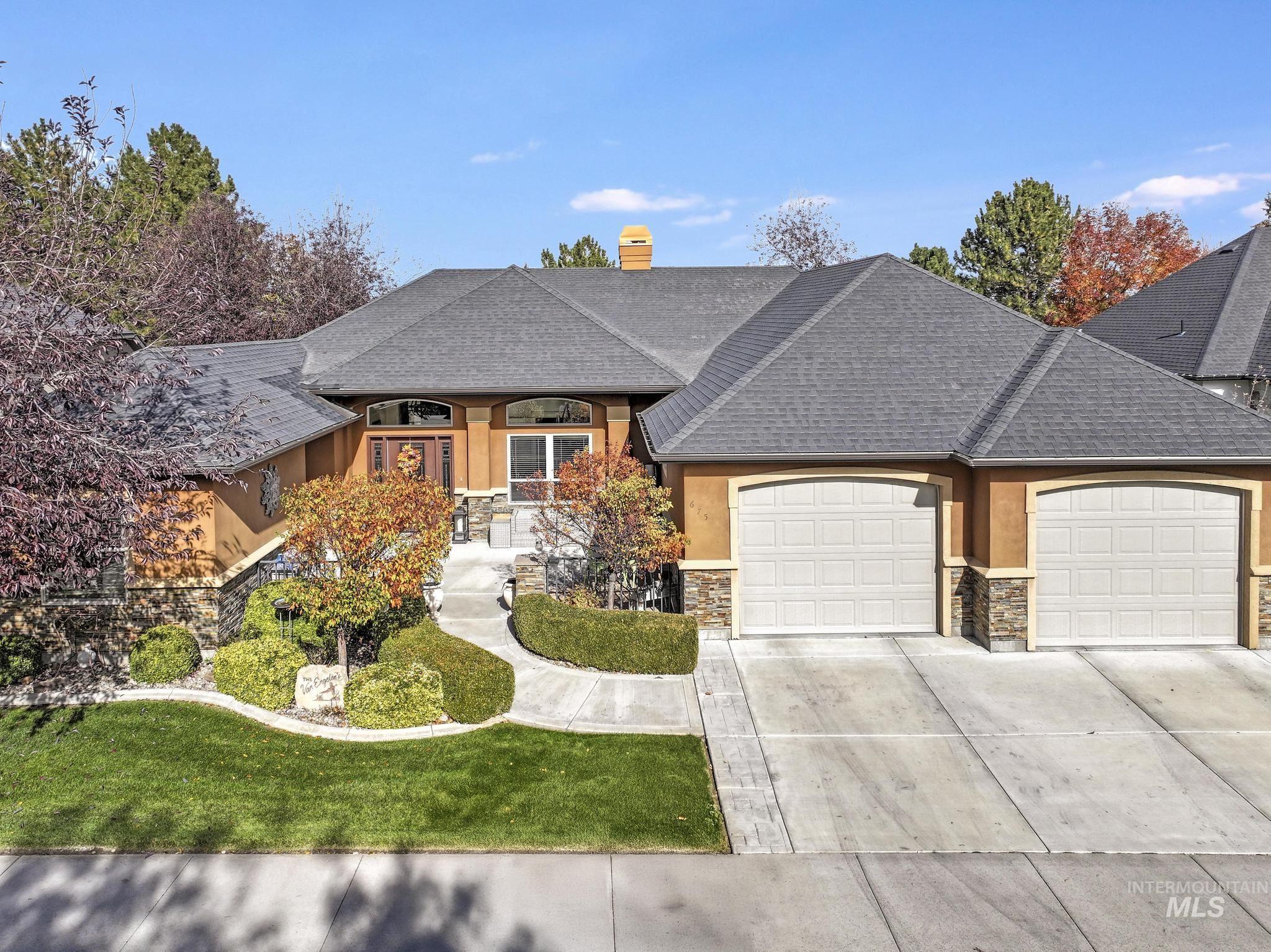 French country style house with roof with shingles, a chimney, a garage, concrete driveway, and a front yard