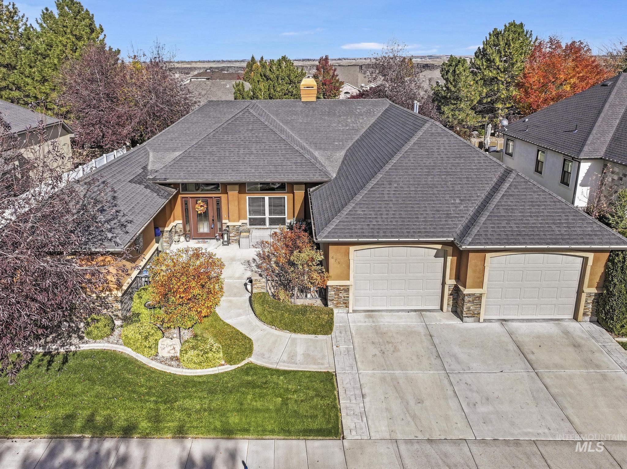 View of front of house featuring a shingled roof, covered porch, a garage, and concrete driveway