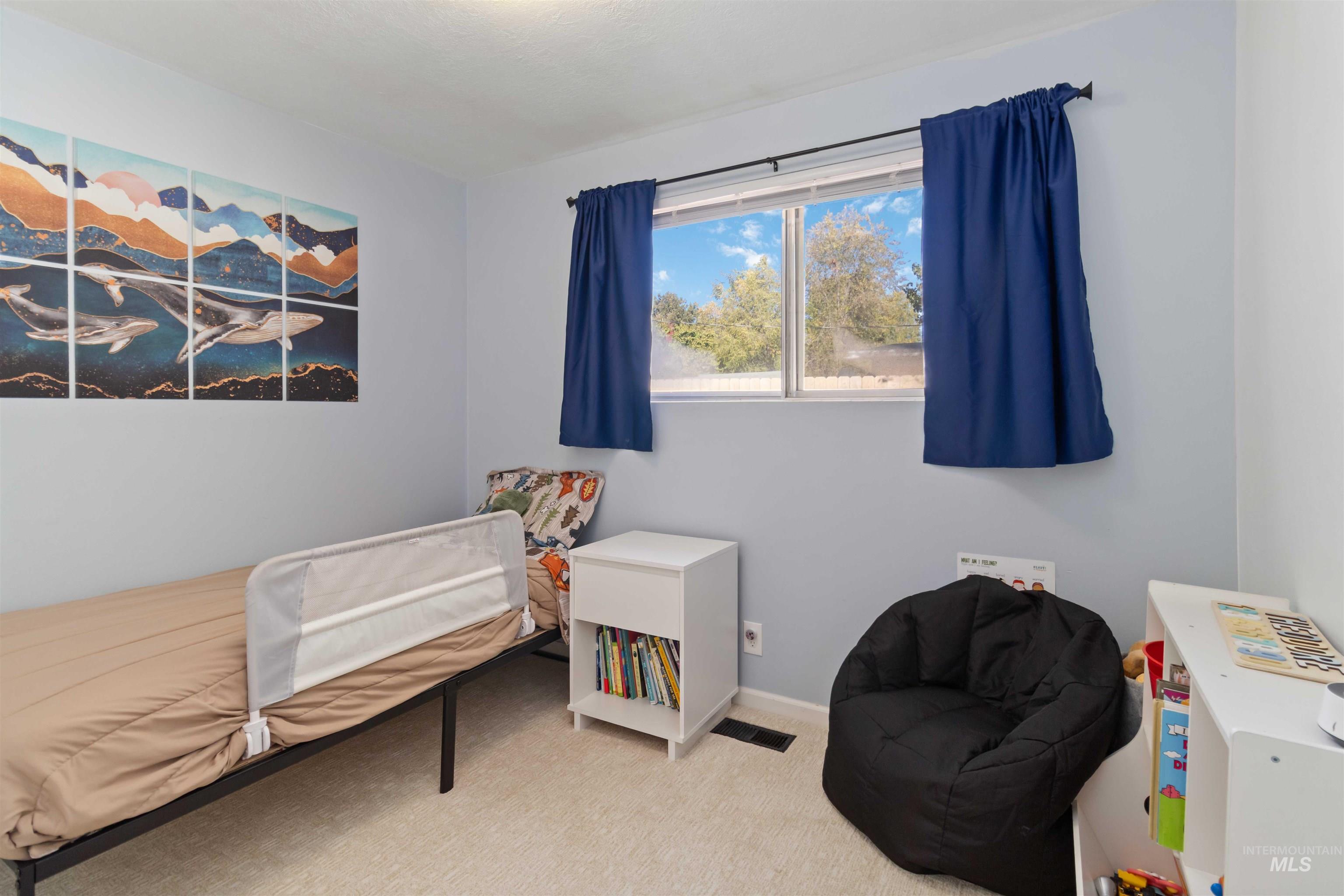 Carpeted bedroom featuring baseboards