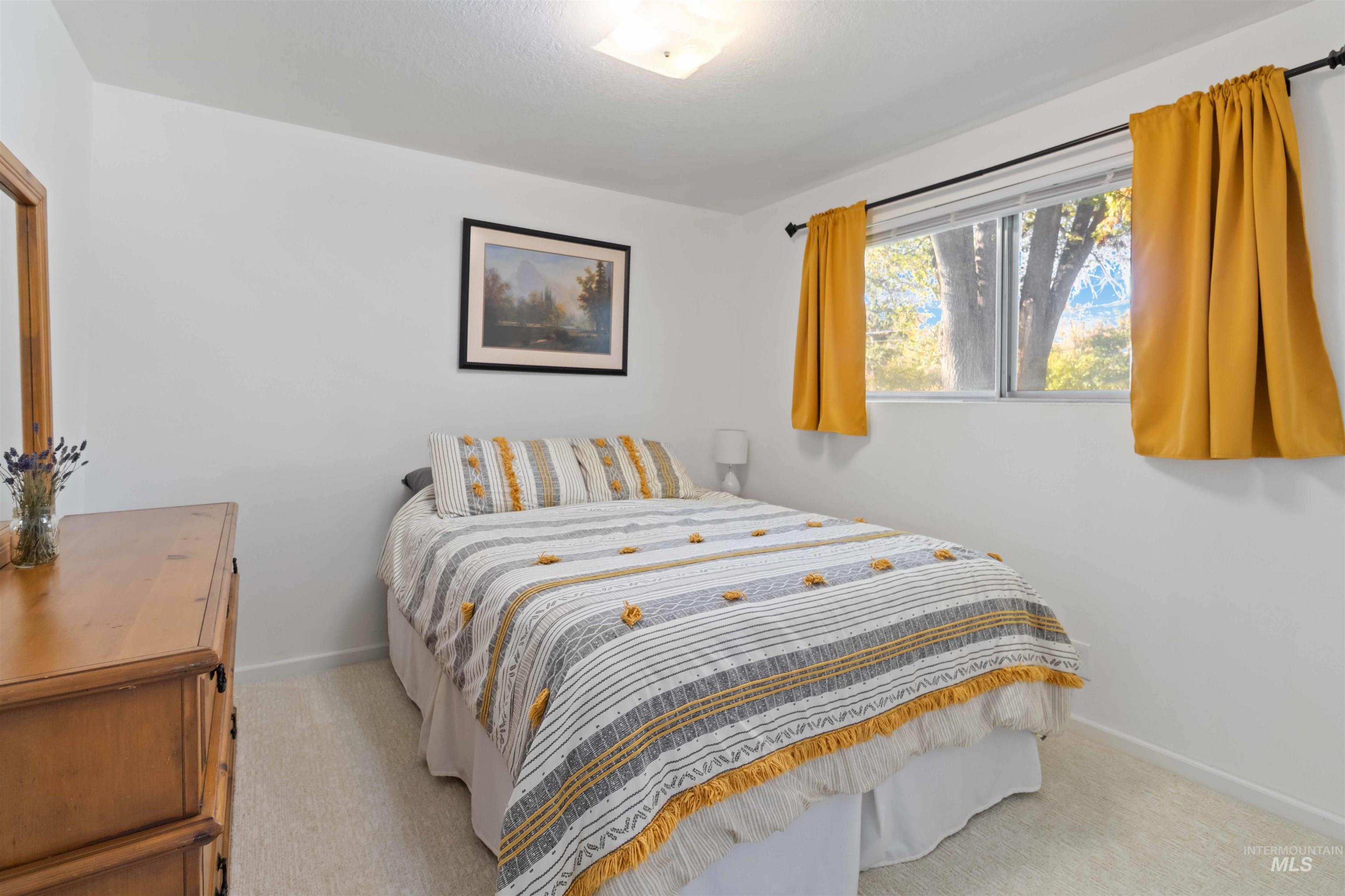 Bedroom featuring light carpet