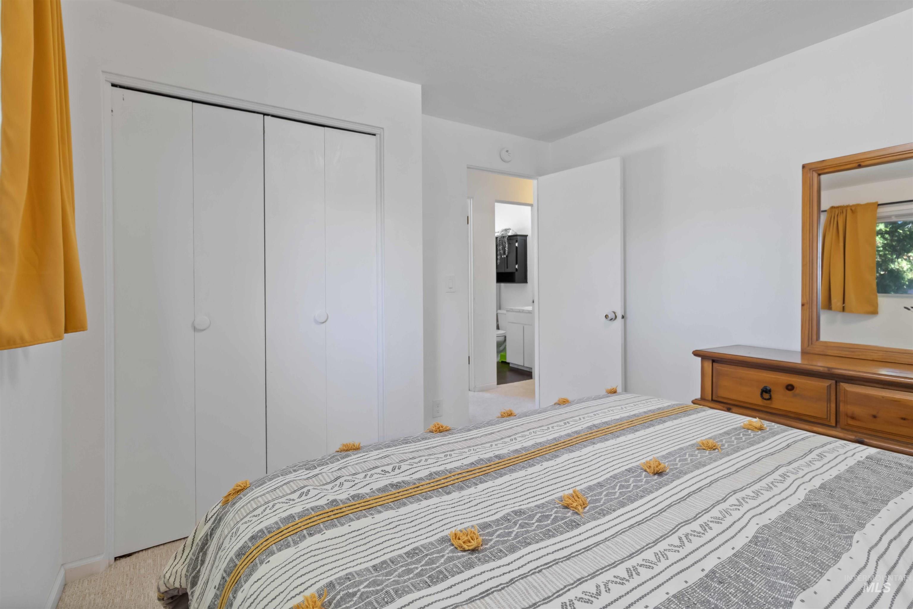 Bedroom featuring carpet and a closet
