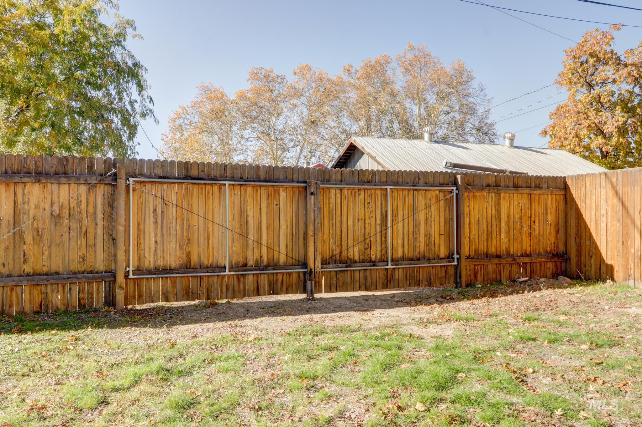 Fenced backyard with a gate