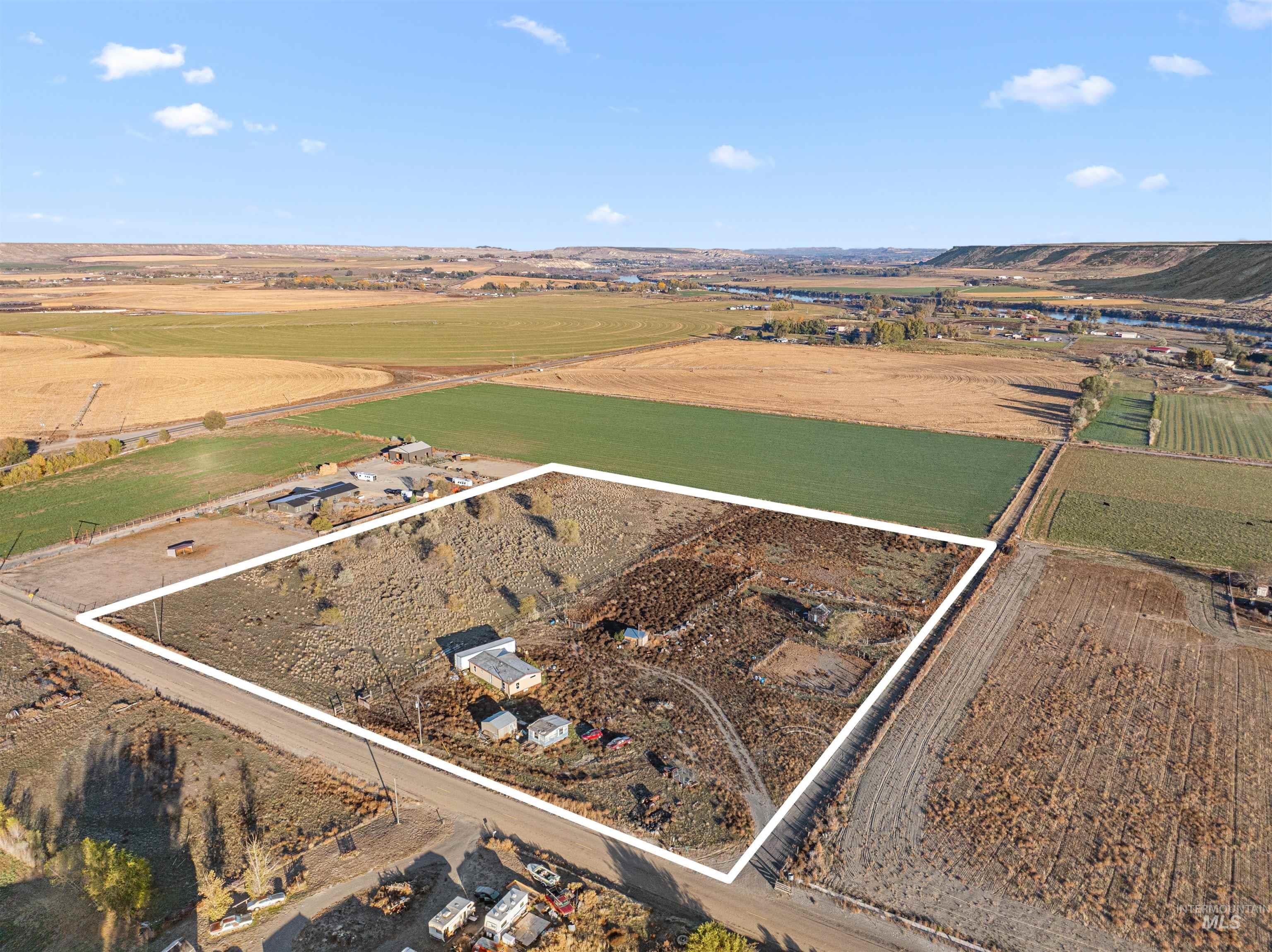 Aerial view of property and surrounding area with property parcel outlined and rural landscape