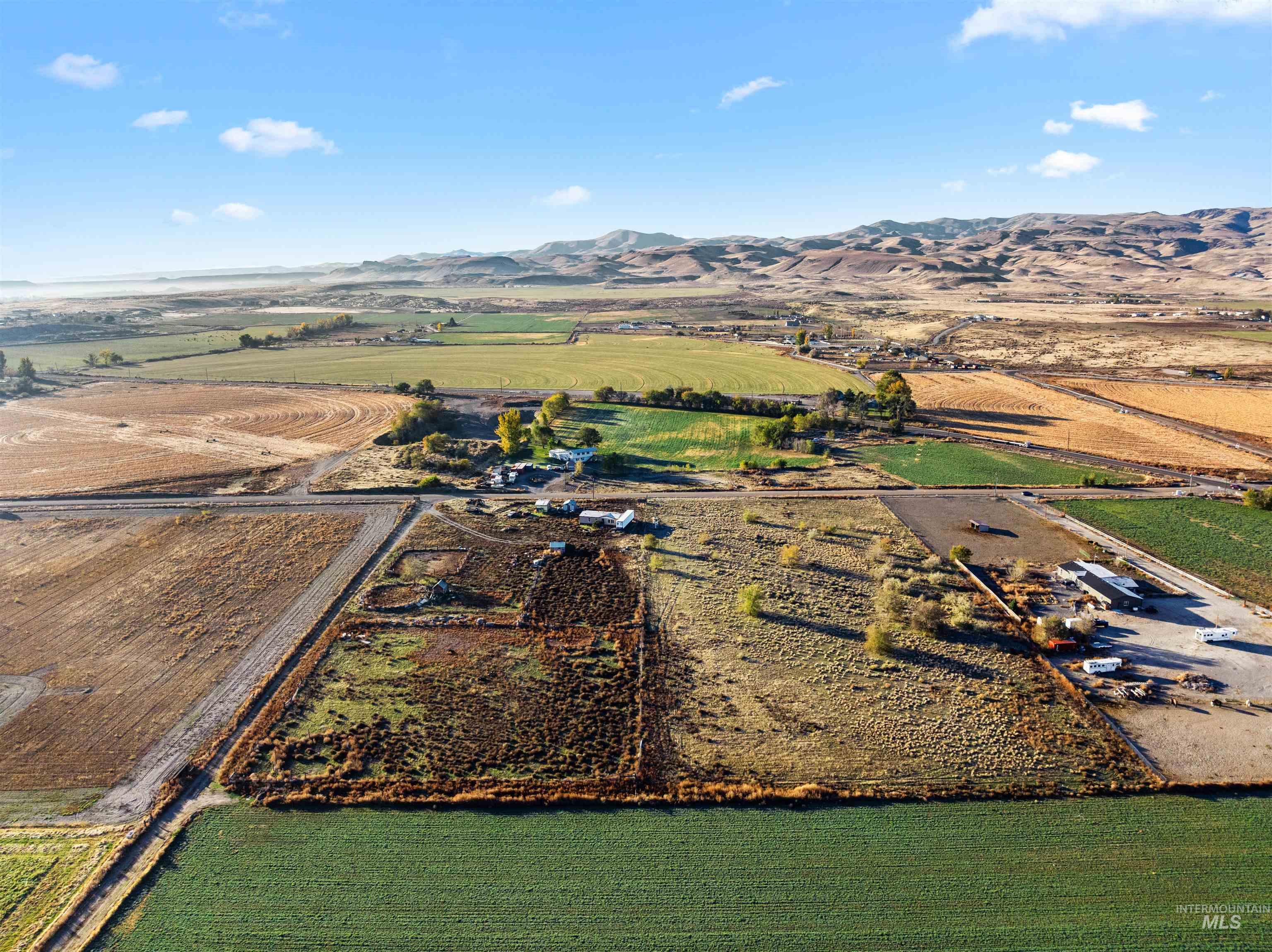 Aerial overview of property's location with rural landscape and mountains