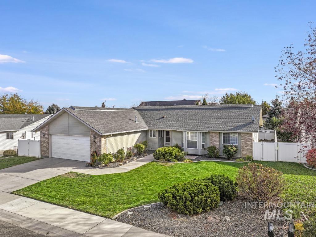 Dutch colonial with brick siding, concrete driveway, a garage, and roof with shingles