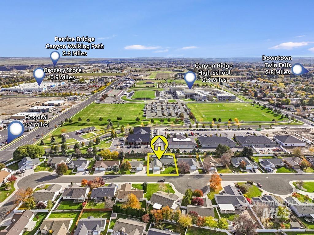 Aerial view of property and surrounding area with nearby suburban area