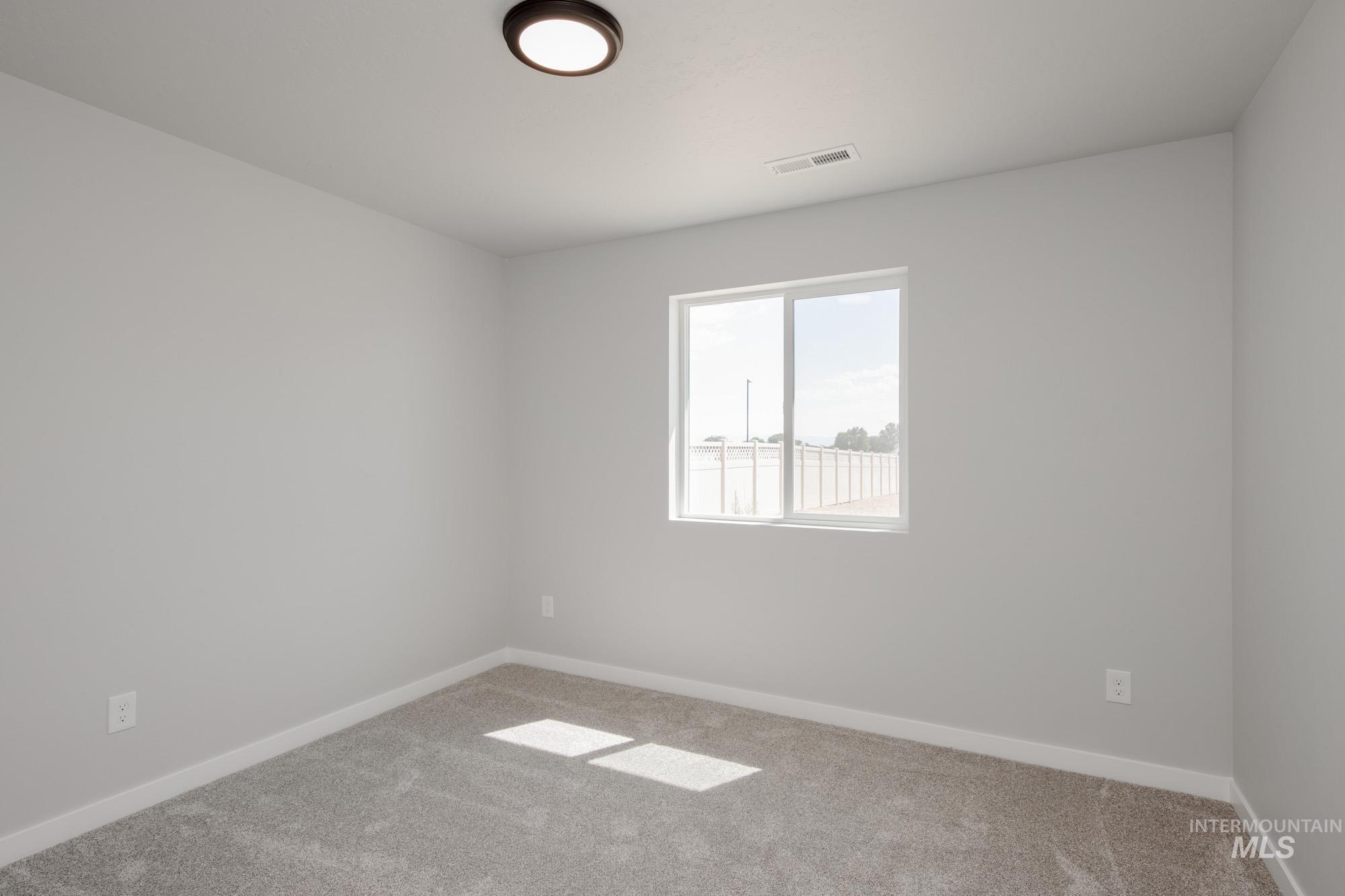 Unfurnished room featuring carpet floors and baseboards