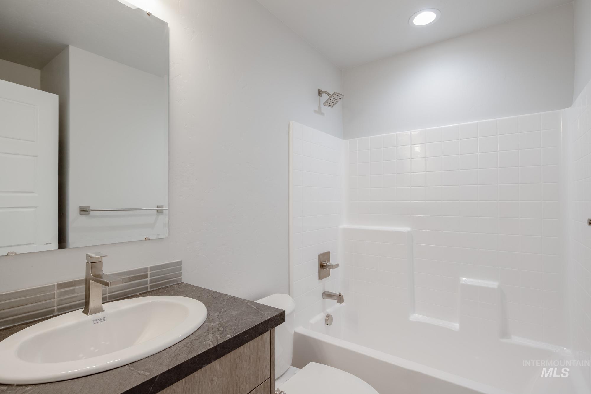 Bathroom featuring vanity and bathtub / shower combination
