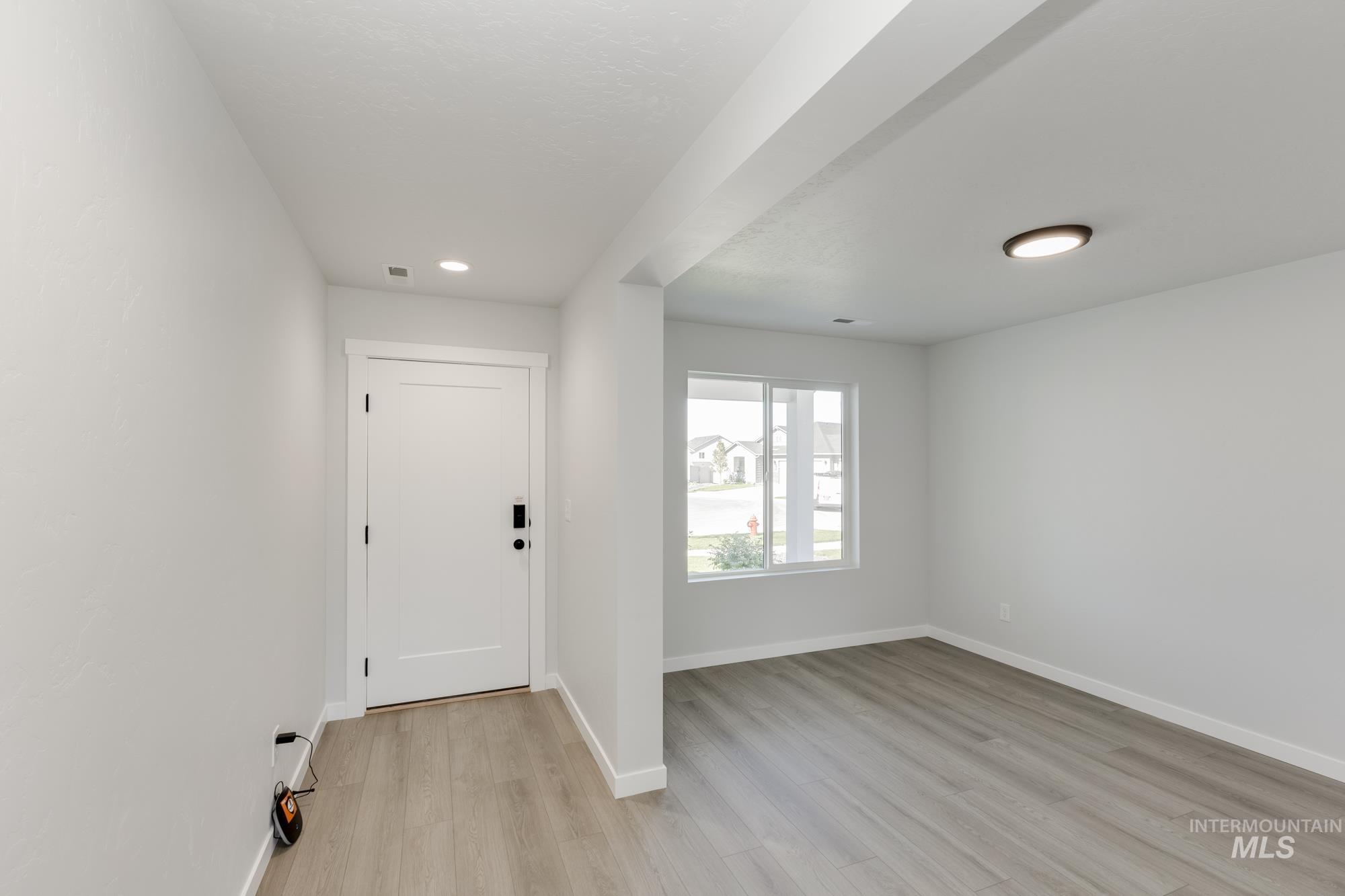 Entryway featuring light wood finished floors and recessed lighting