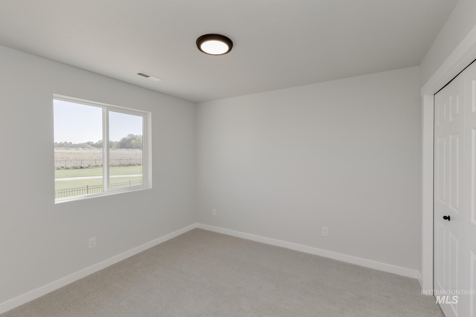Unfurnished bedroom featuring a closet and light carpet