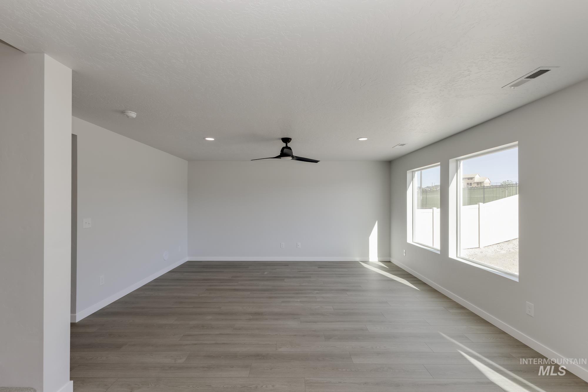 Unfurnished room with light wood-type flooring, a ceiling fan, and recessed lighting