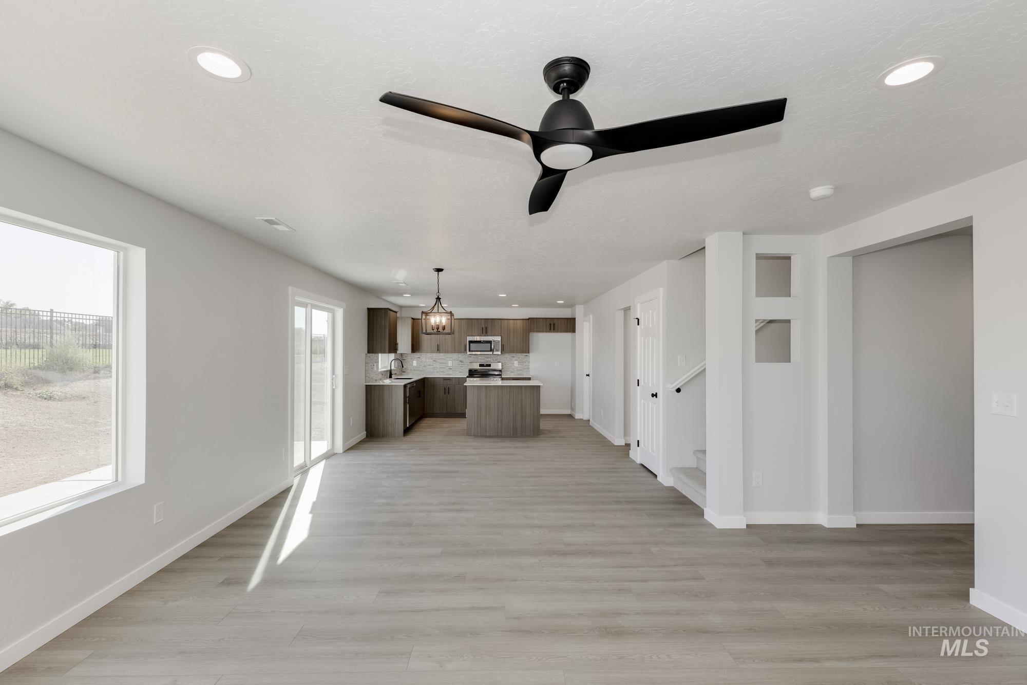 Unfurnished living room with recessed lighting, light wood-style floors, and ceiling fan