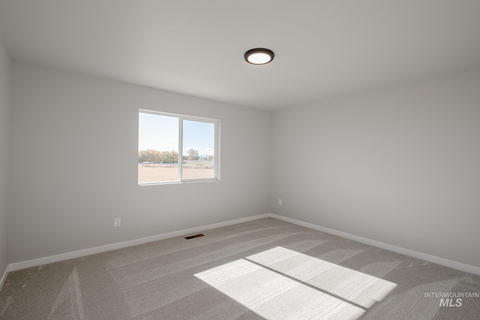 Unfurnished room with carpet