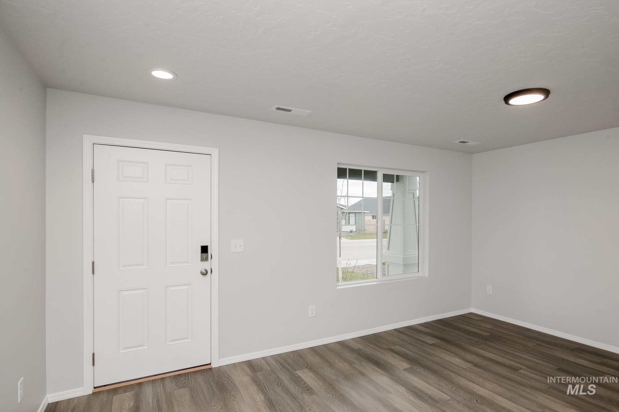 Foyer featuring dark wood-style floors and recessed lighting