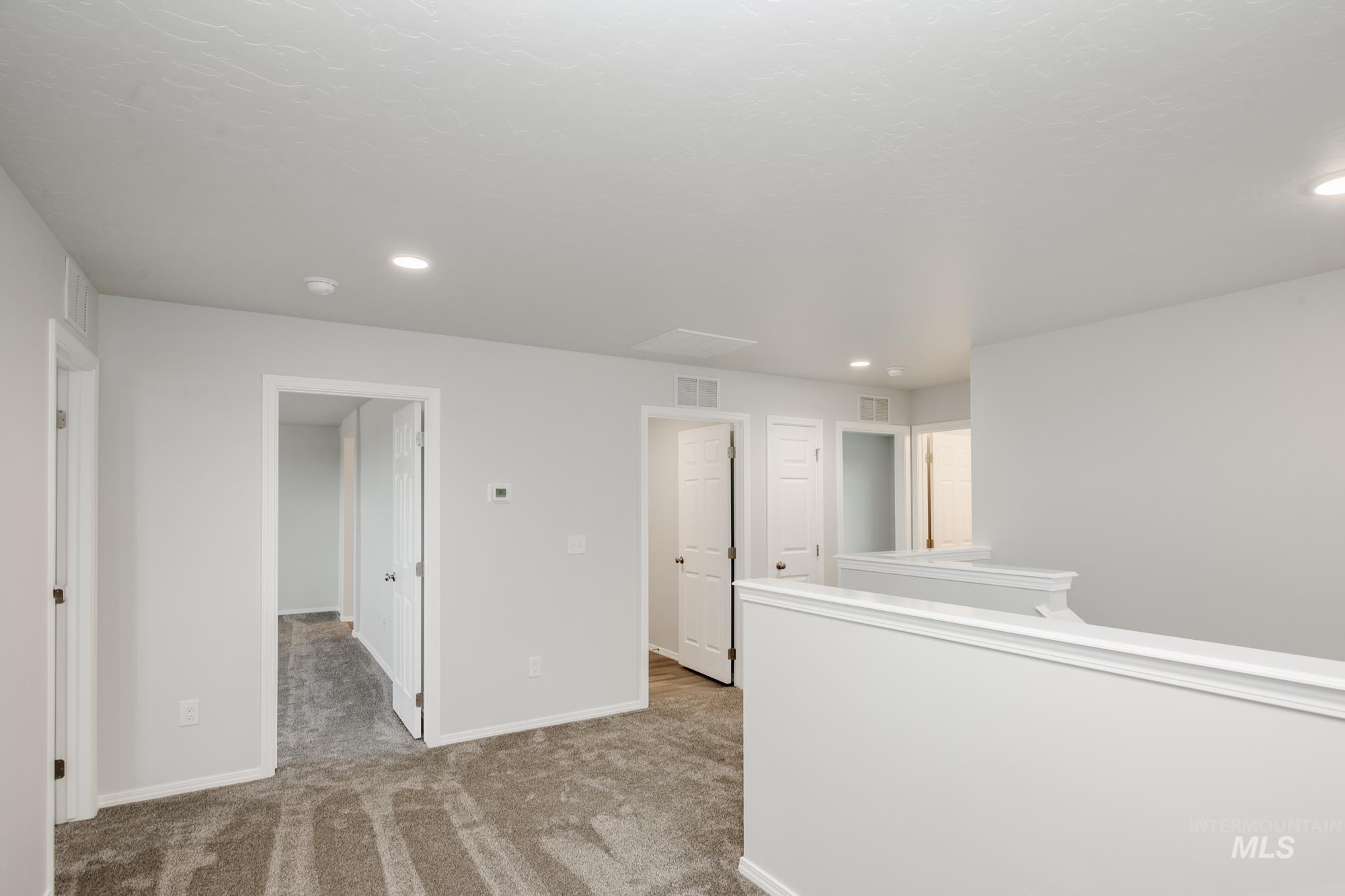 Spare room with light carpet and recessed lighting