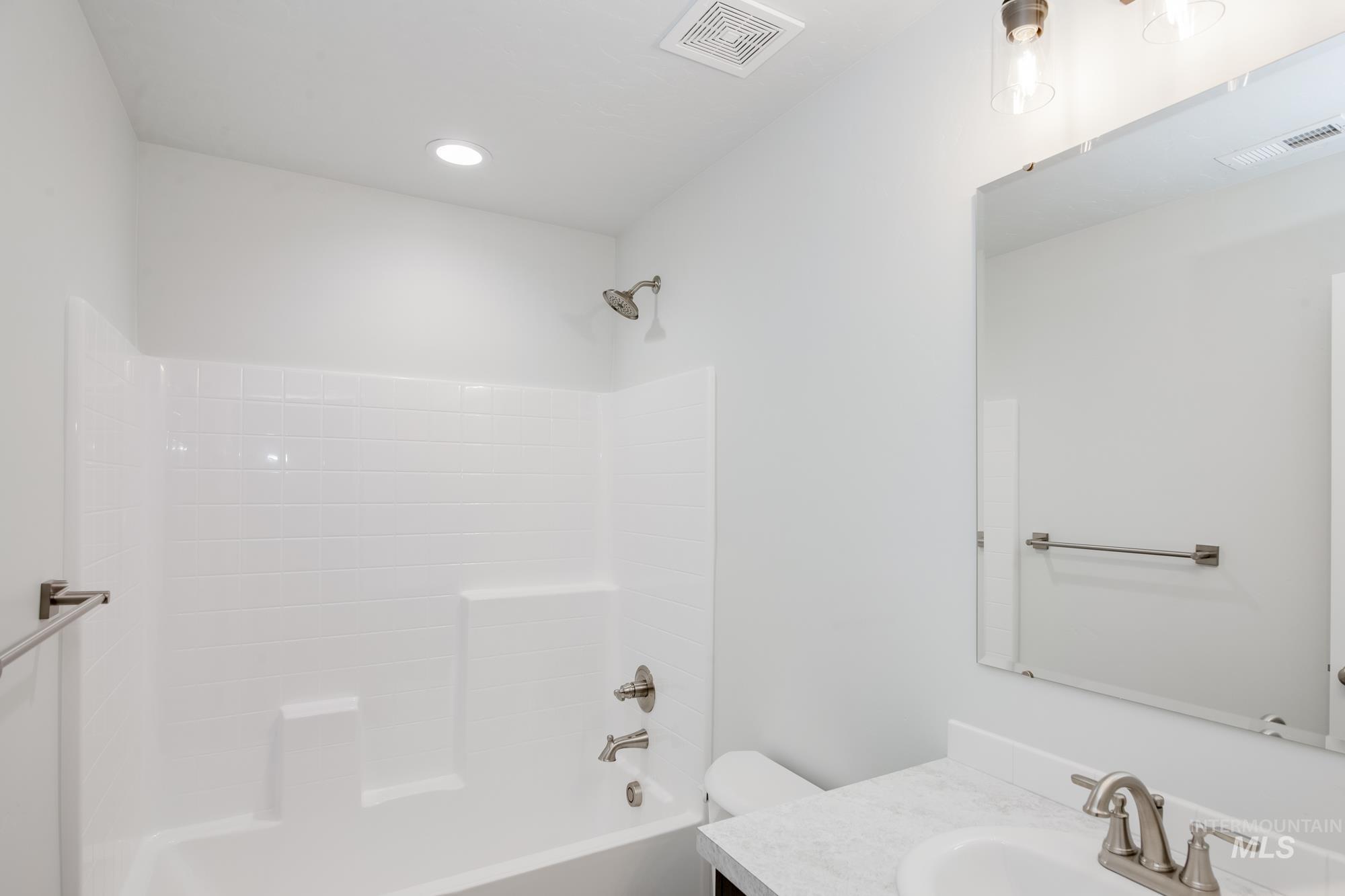 Full bath with bathing tub / shower combination, vanity, and recessed lighting