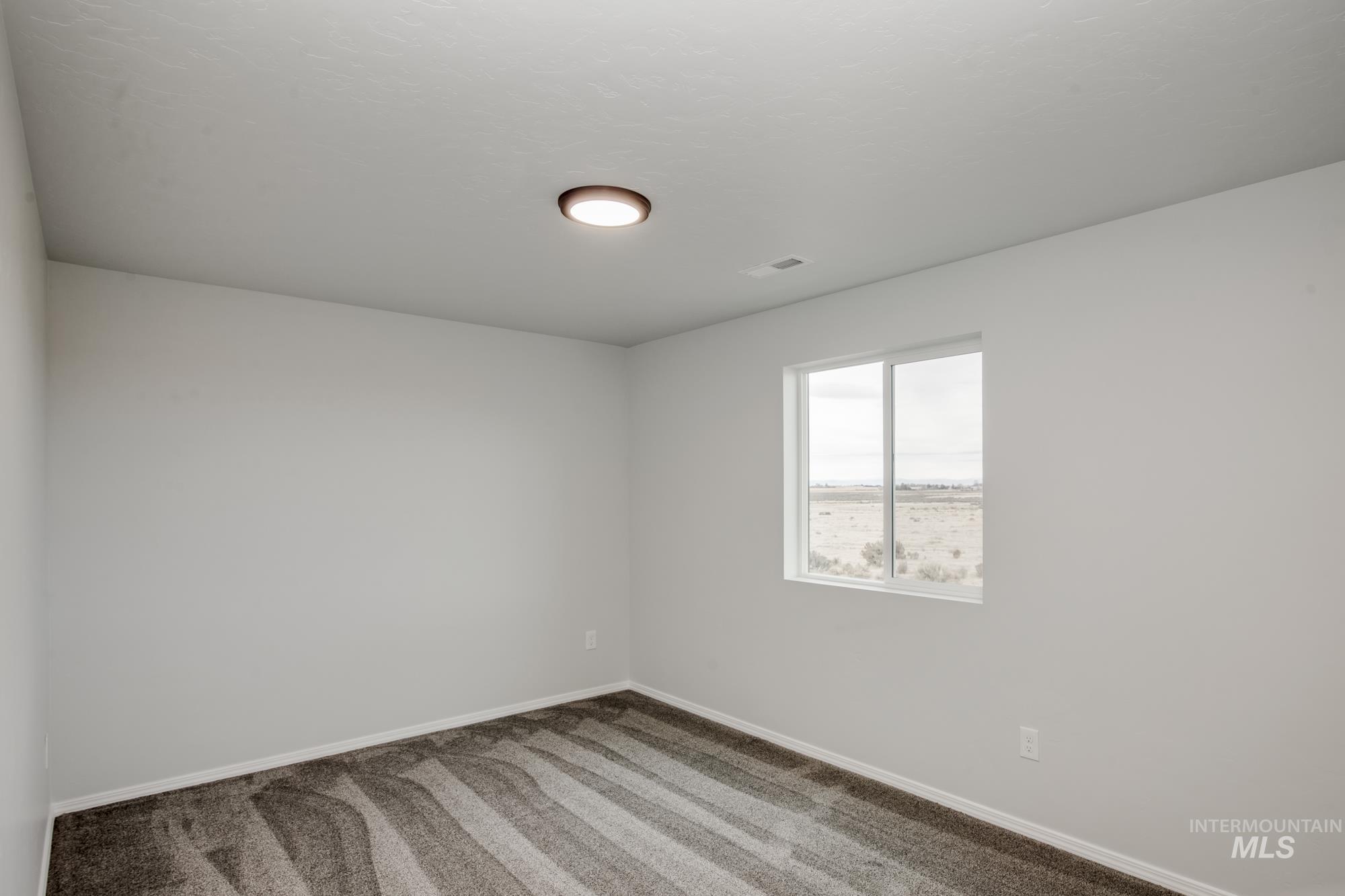 Unfurnished room featuring carpet floors and baseboards