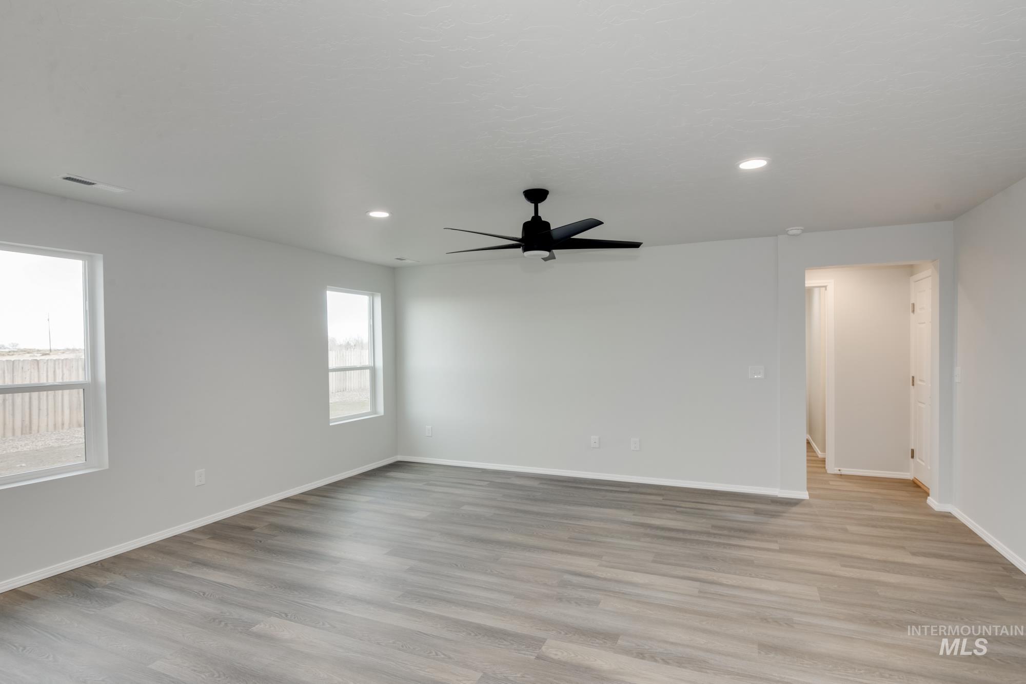 Unfurnished room with light wood finished floors, recessed lighting, and ceiling fan
