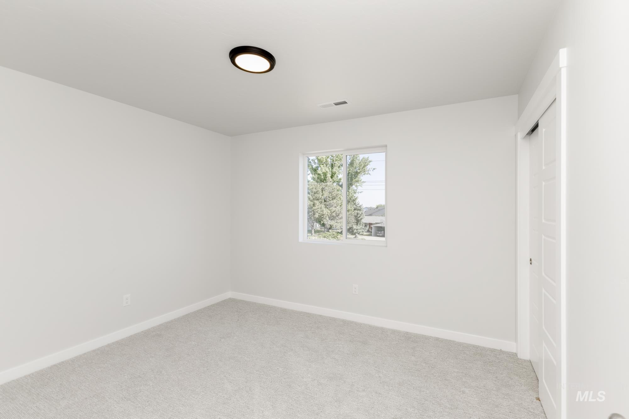 Unfurnished bedroom with a closet and light carpet