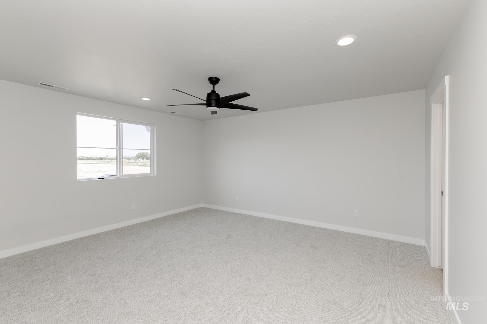 Empty room featuring light carpet, recessed lighting, and ceiling fan