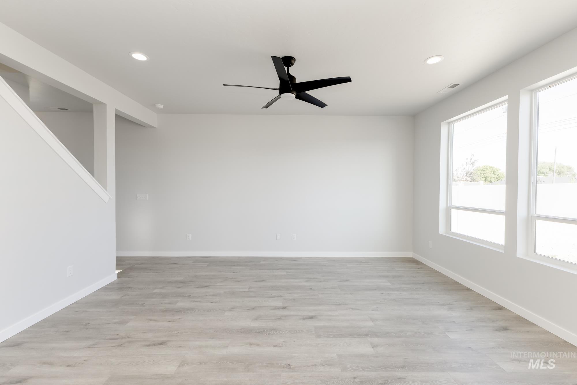 Empty room with recessed lighting, light wood-style flooring, and a ceiling fan