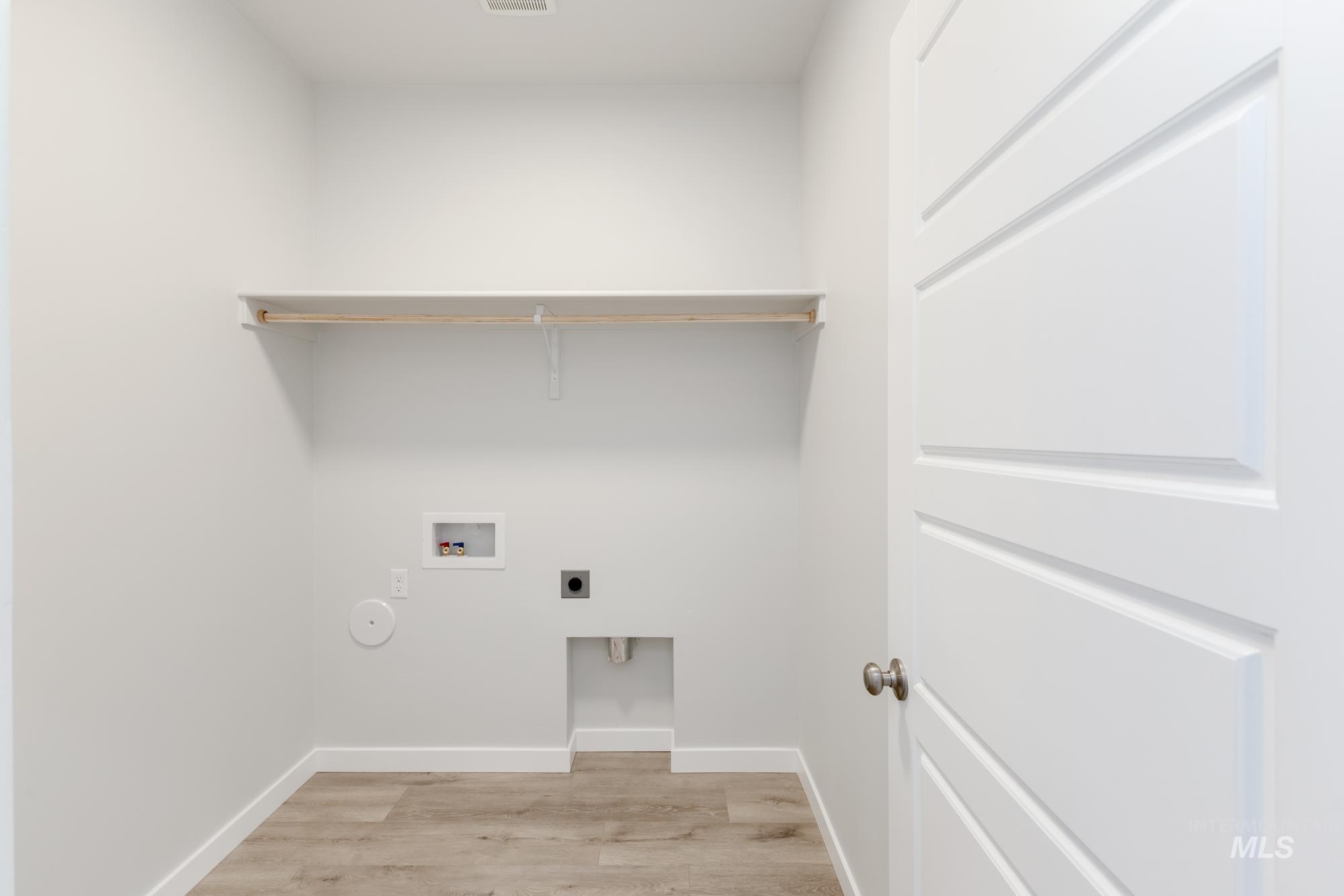 Laundry area featuring electric dryer hookup, light wood-style floors, and hookup for a washing machine