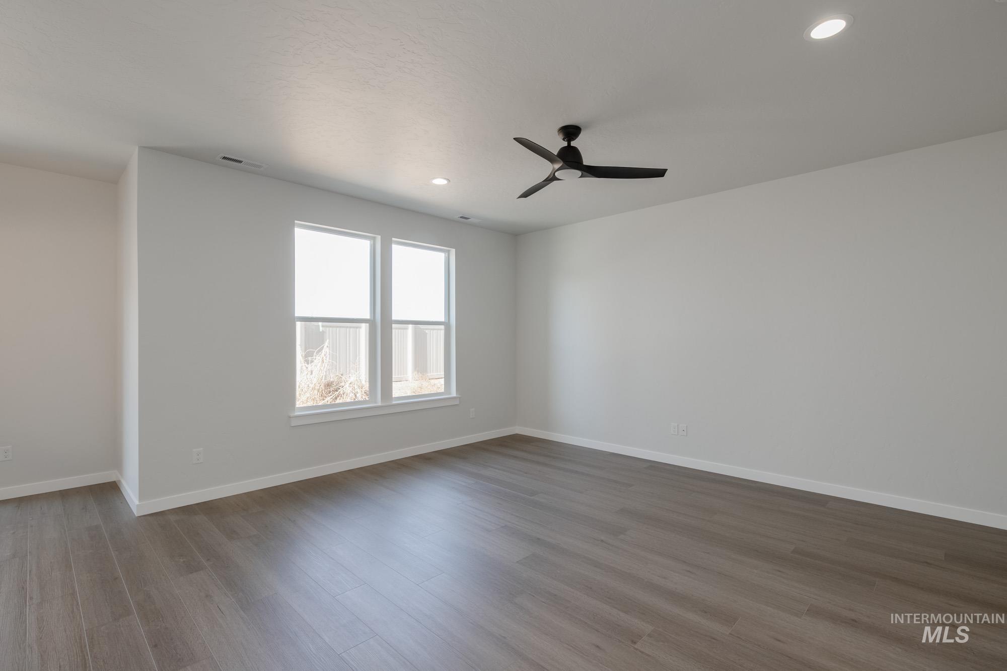 Spare room with light wood finished floors, recessed lighting, and ceiling fan