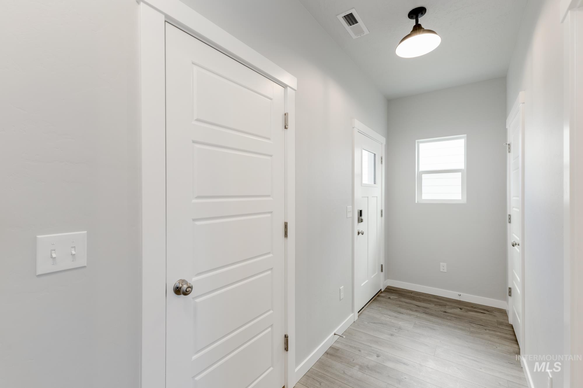 Entryway with baseboards and wood finished floors