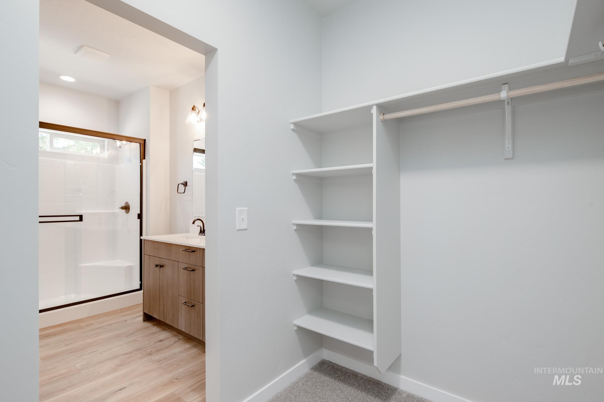 Walk in closet featuring light wood finished floors