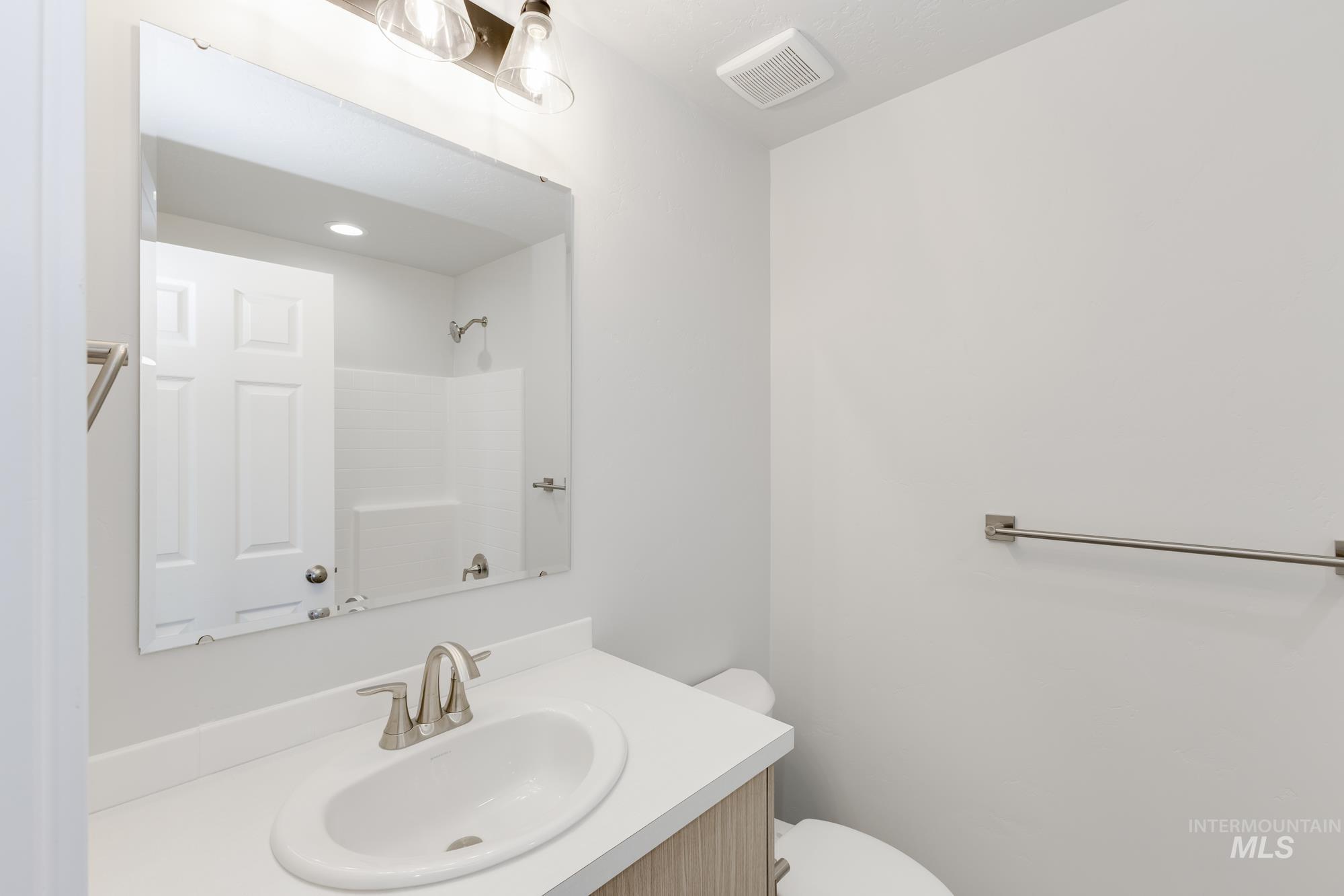 Full bath with vanity and a shower