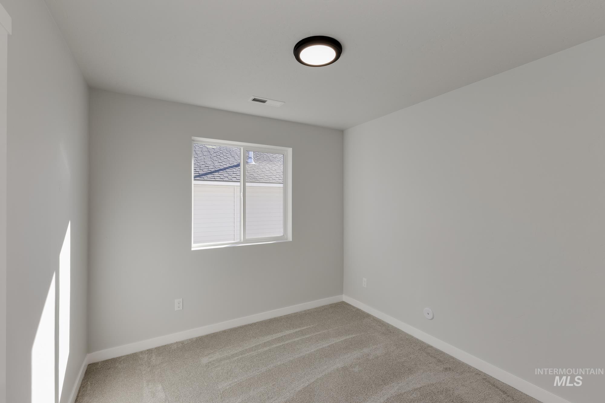 Unfurnished room with light colored carpet