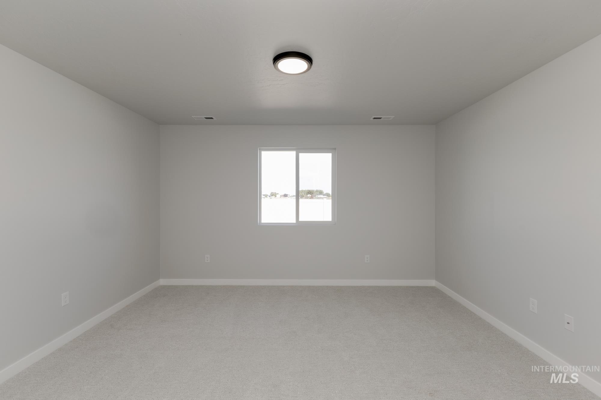 Unfurnished room with light carpet and baseboards