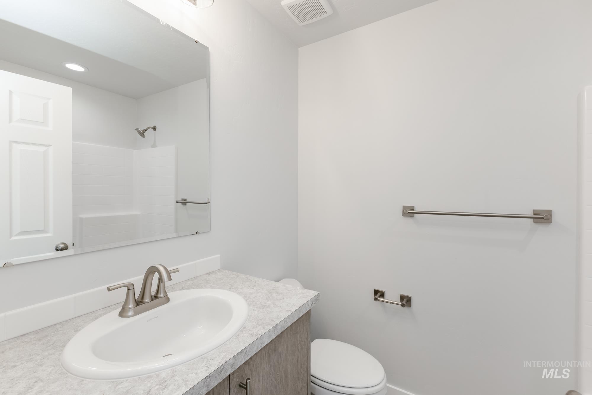 Bathroom featuring vanity and a shower