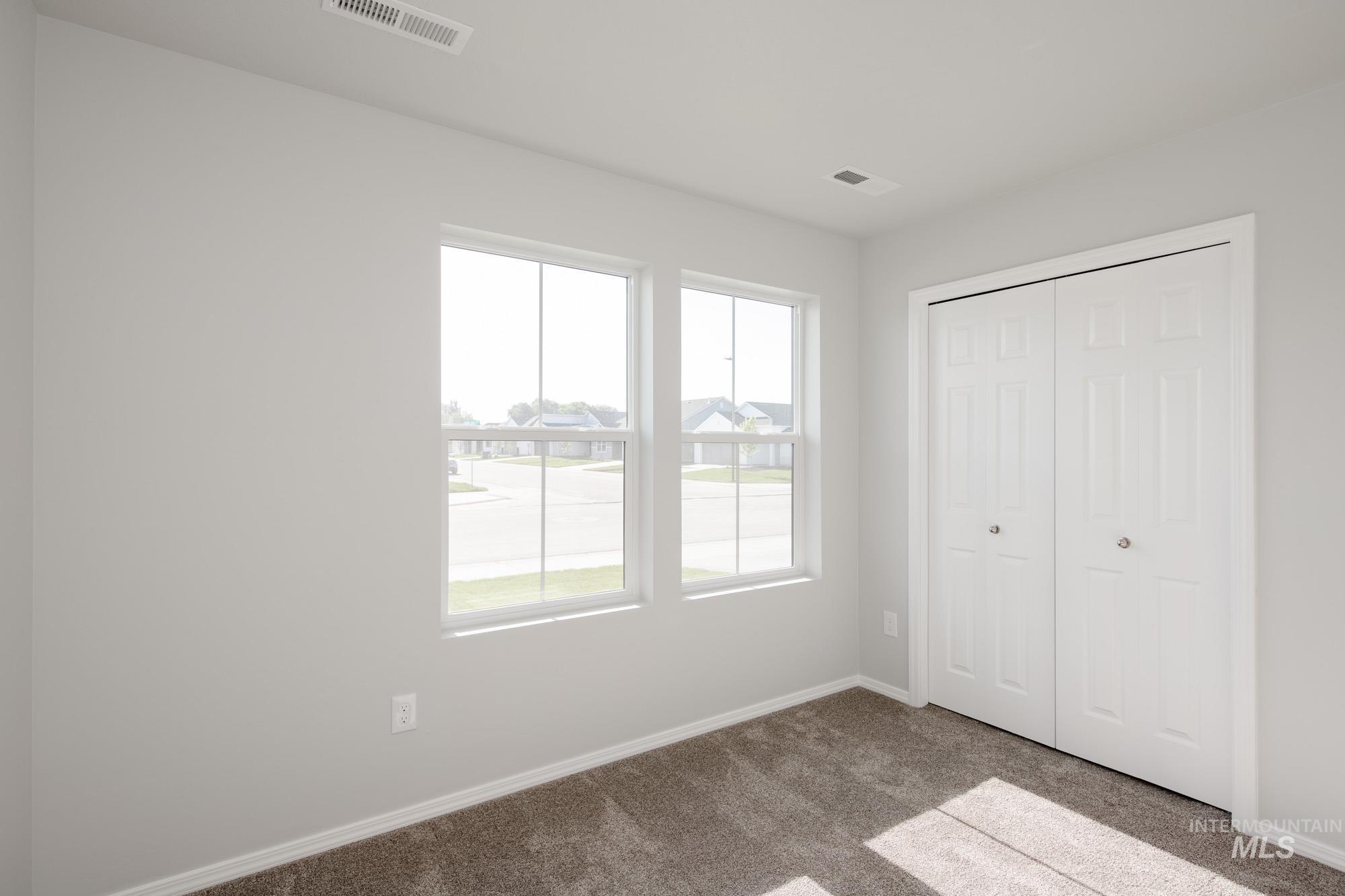 Unfurnished bedroom with carpet and a closet