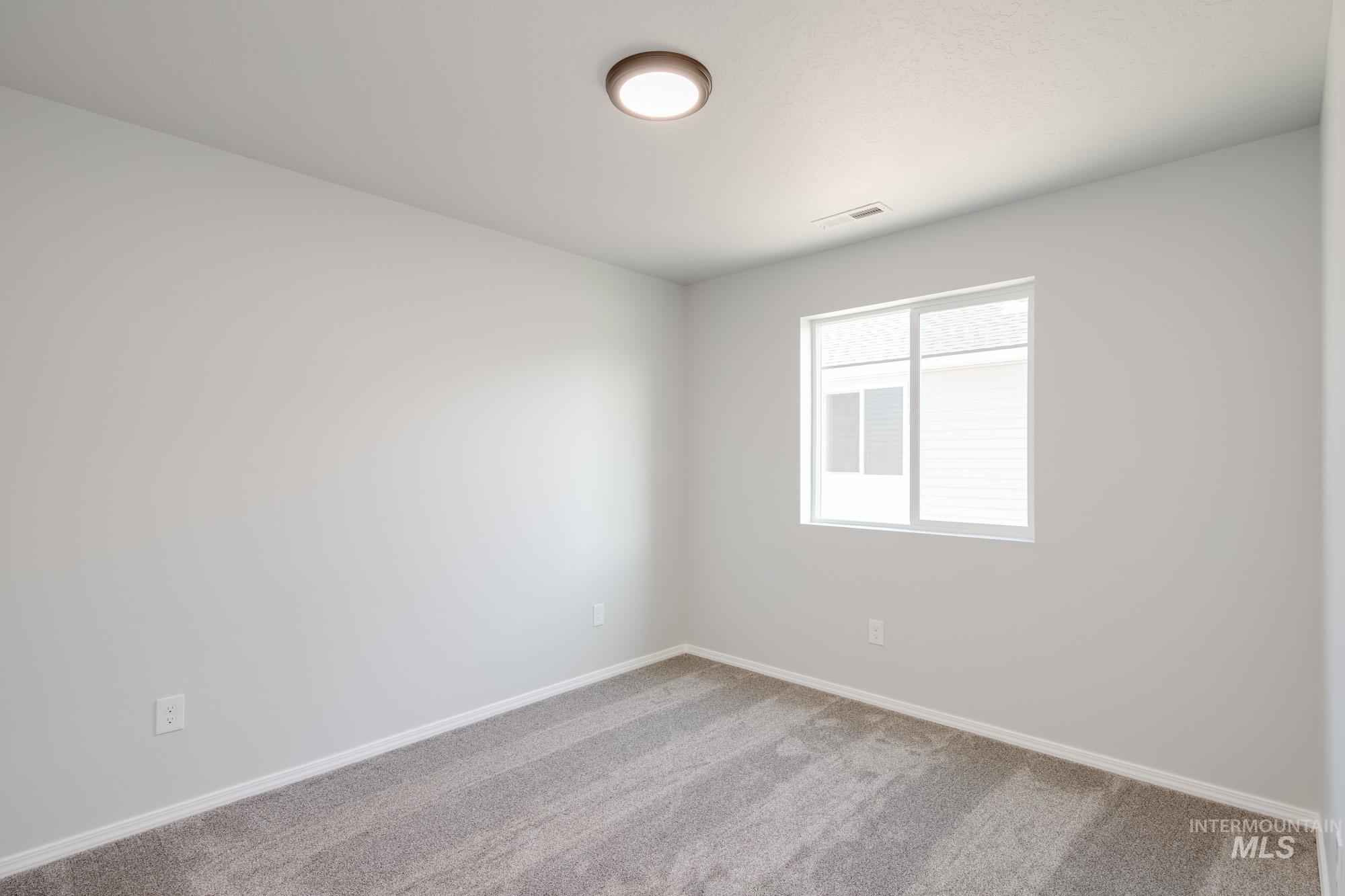 Empty room featuring carpet floors and baseboards