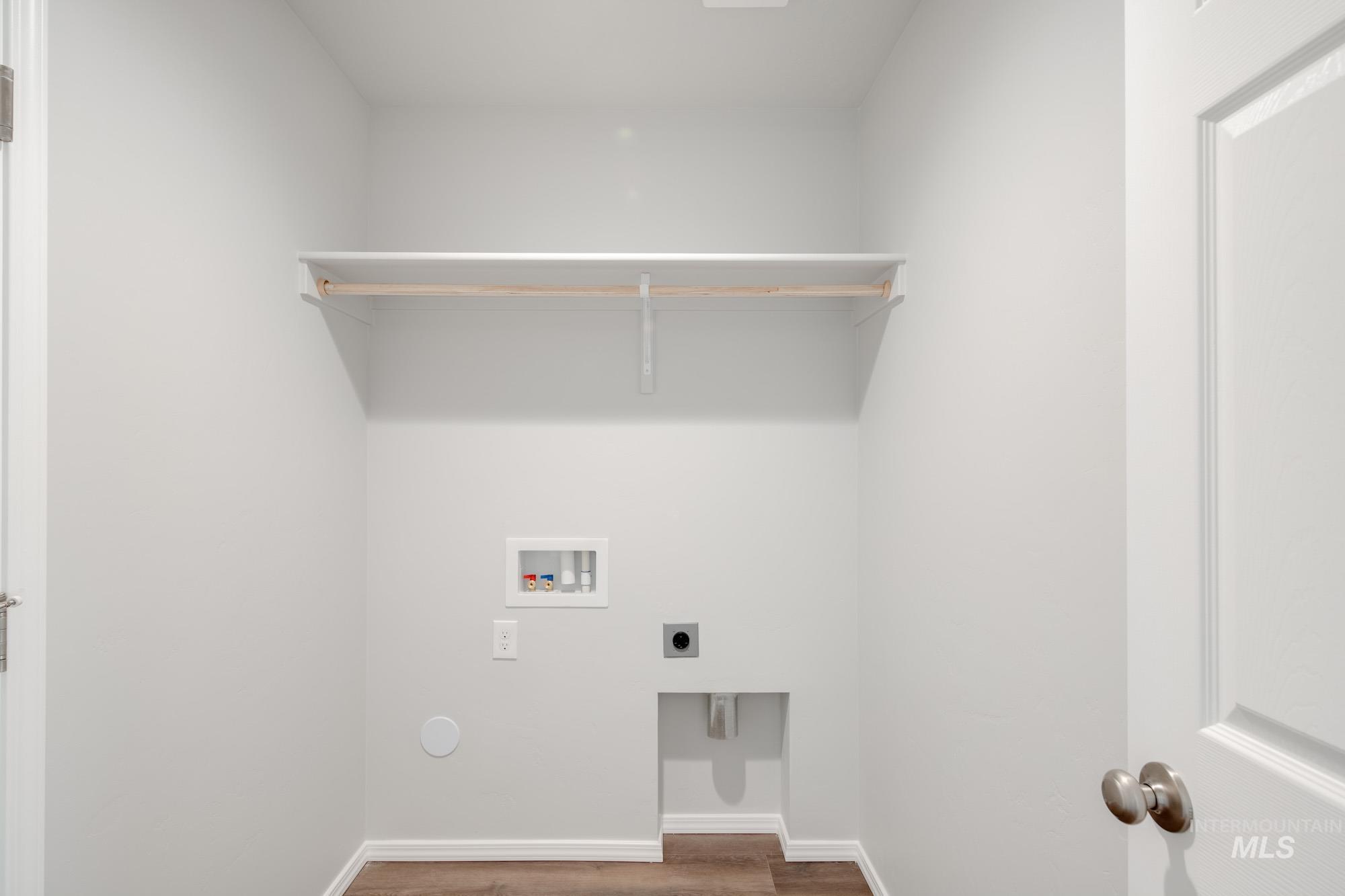 Washroom featuring wood finished floors, hookup for an electric dryer, and hookup for a washing machine