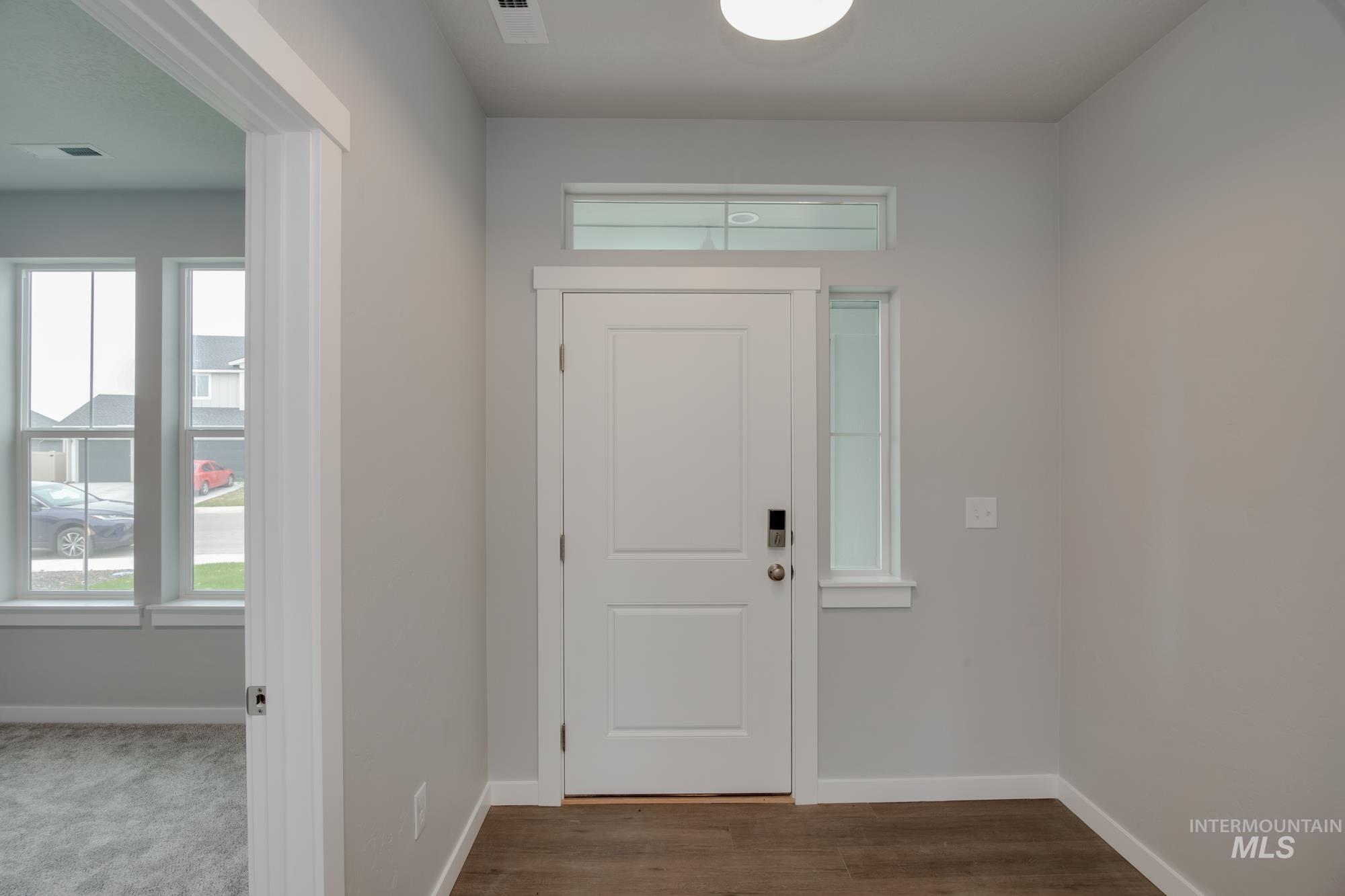 Foyer with healthy amount of natural light and wood finished floors