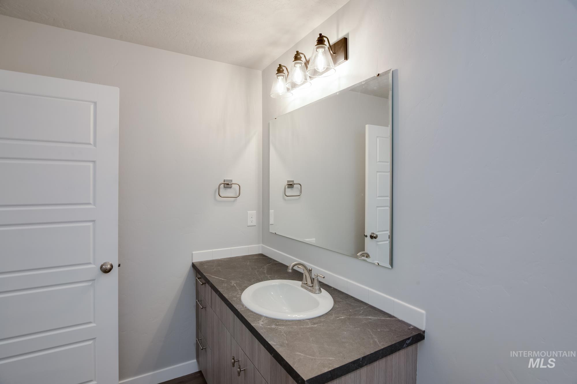 Bathroom featuring vanity and baseboards