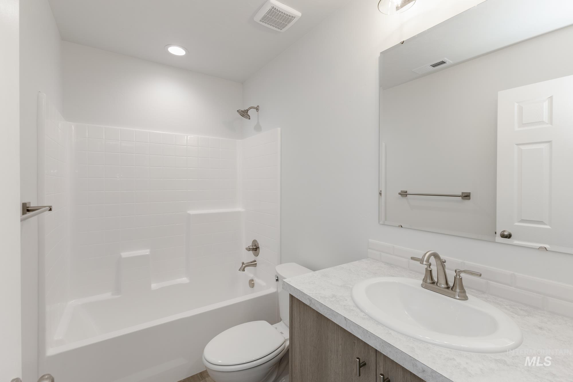 Bathroom with vanity and bathing tub / shower combination