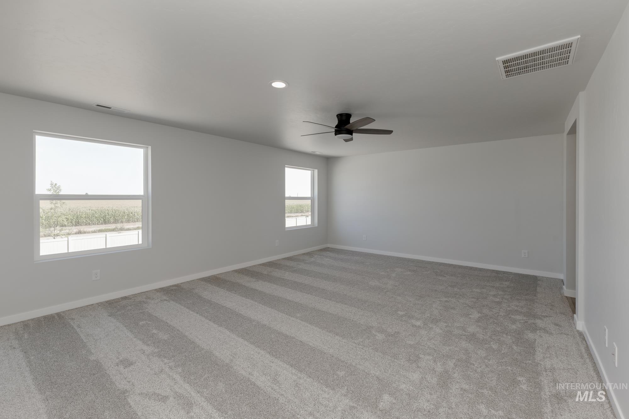 Unfurnished room featuring light carpet, recessed lighting, and ceiling fan