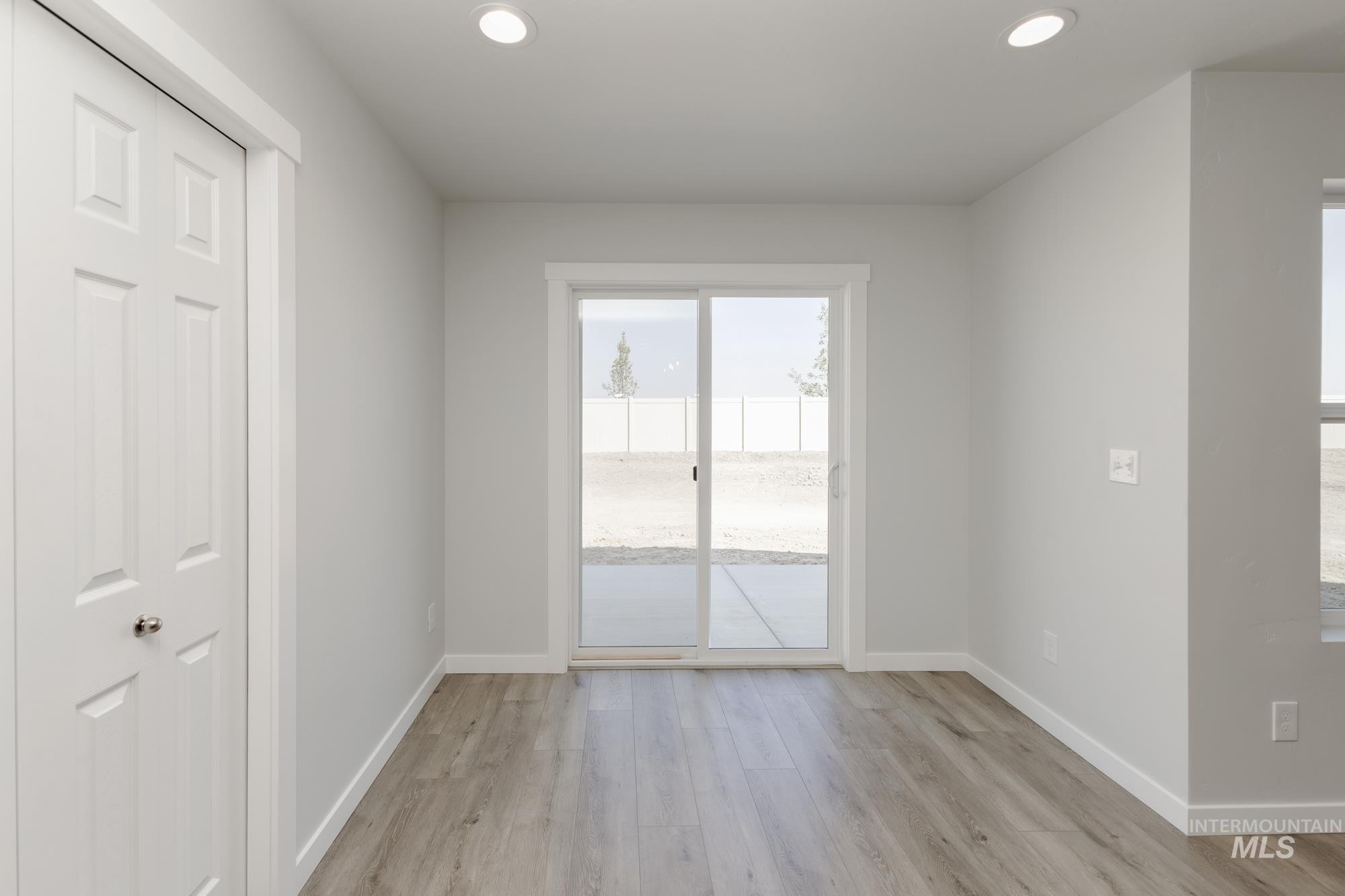 Empty room with recessed lighting and light wood-style floors
