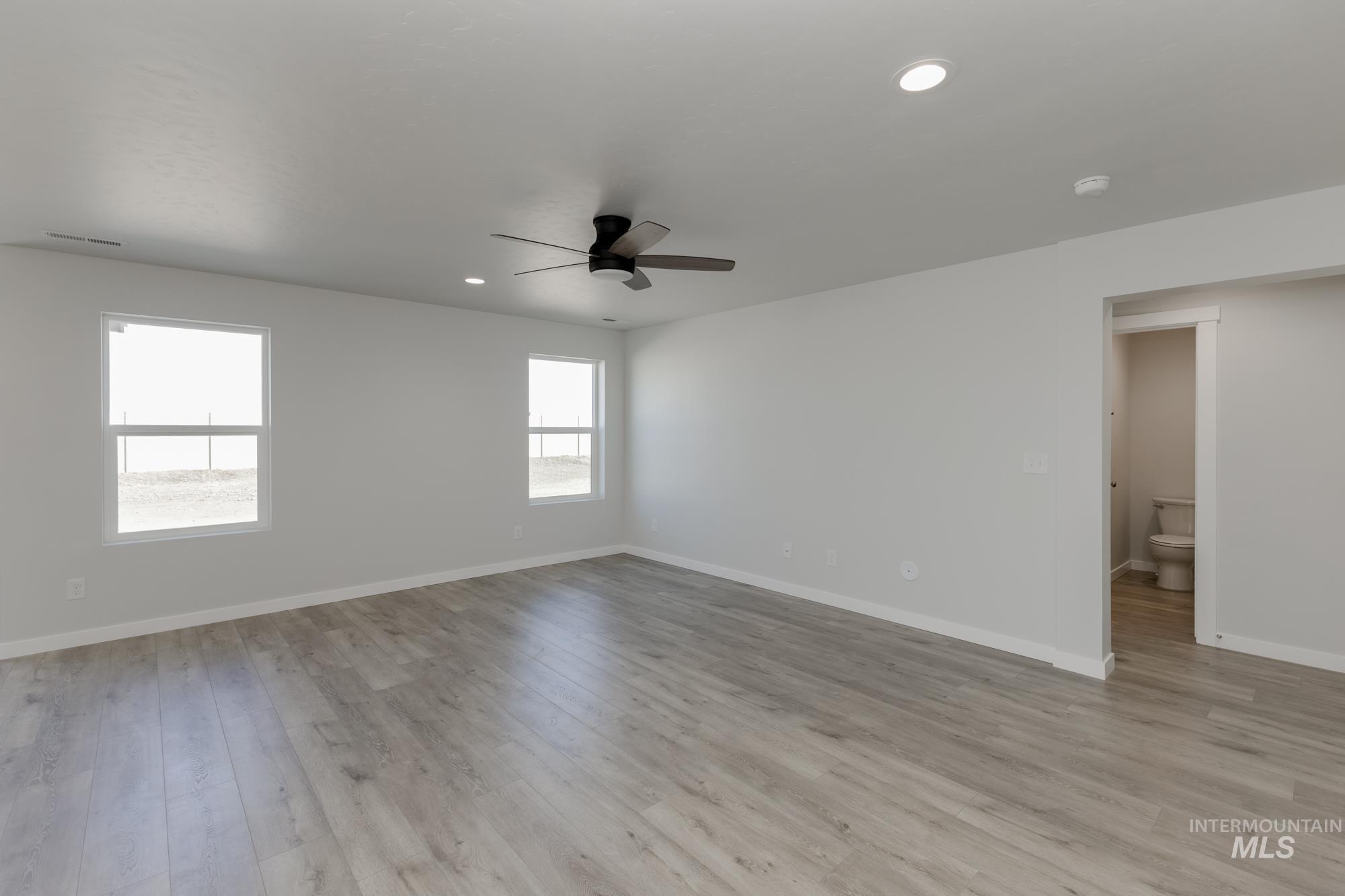 Empty room featuring light wood-style flooring, recessed lighting, and a ceiling fan
