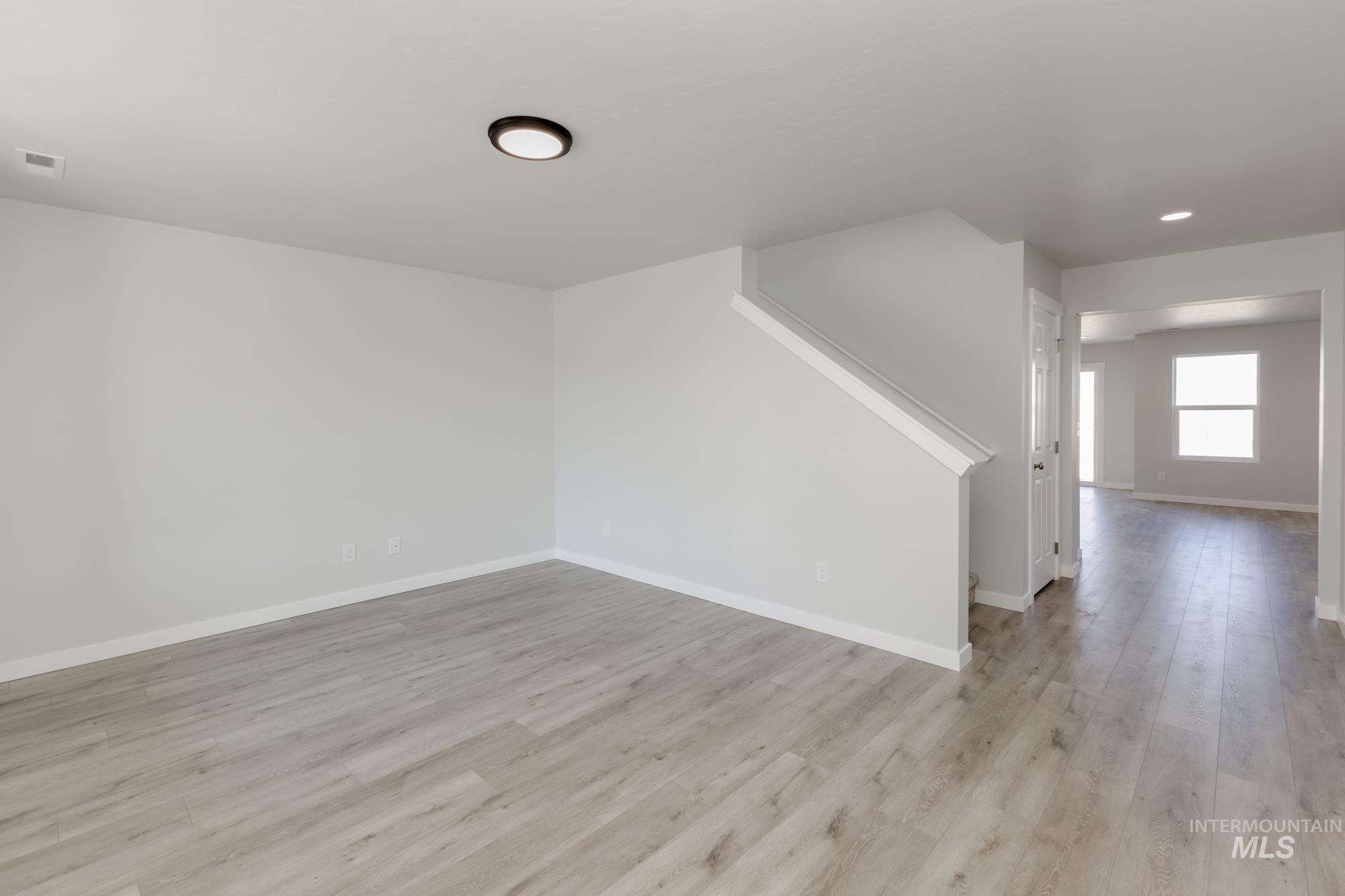Unfurnished living room featuring light wood finished floors and recessed lighting