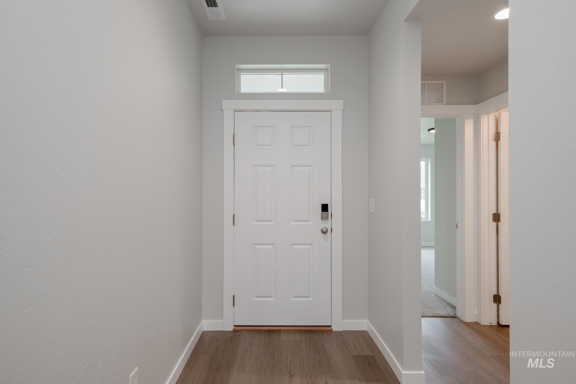 Entryway with light wood-style floors and baseboards