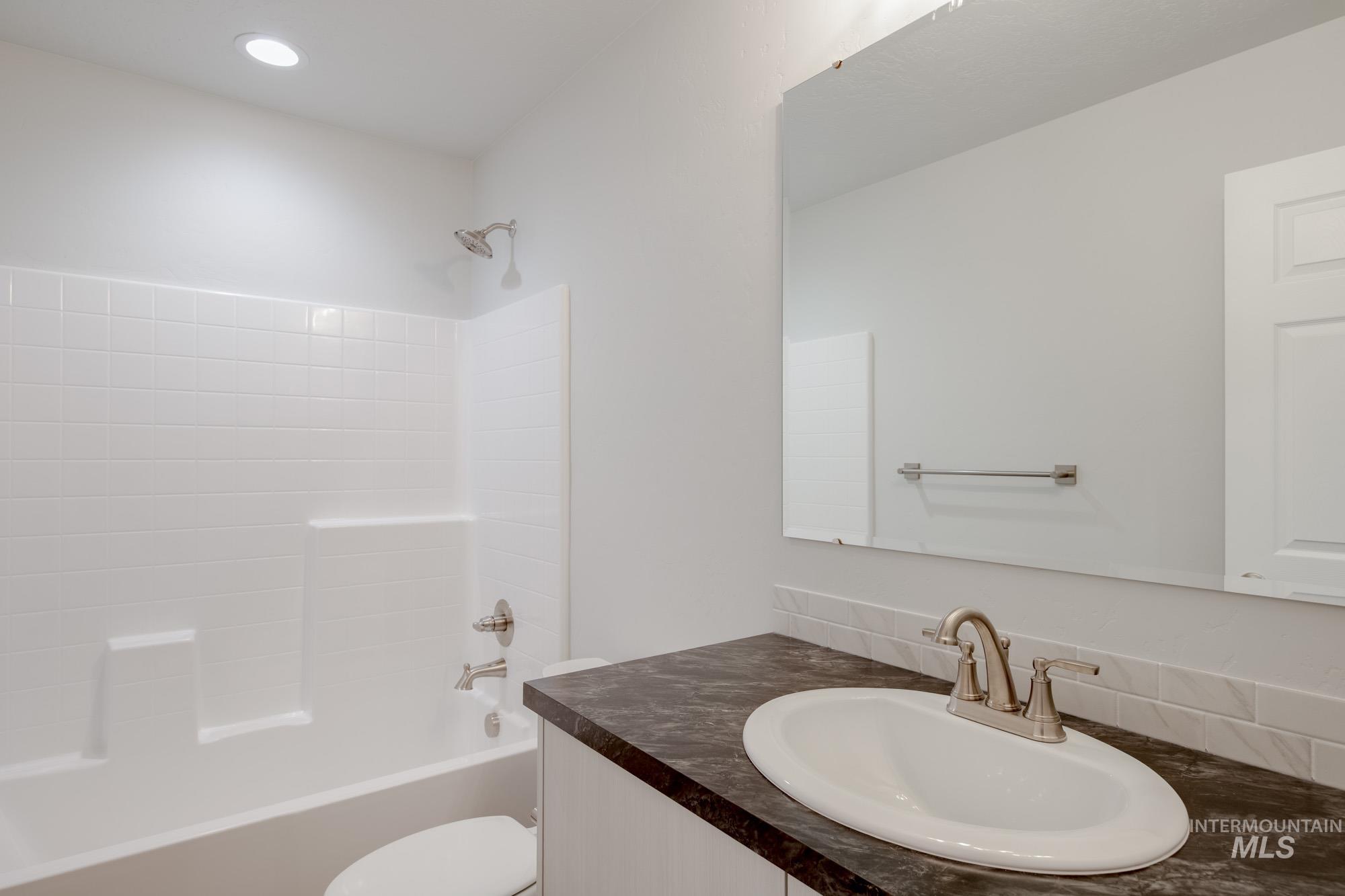 Full bath featuring shower / washtub combination and vanity