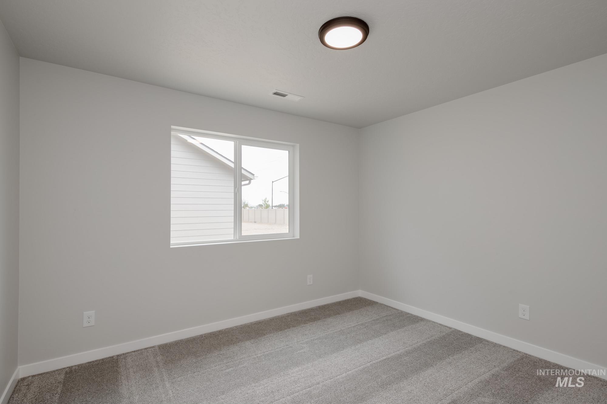 Unfurnished room featuring carpet floors and baseboards