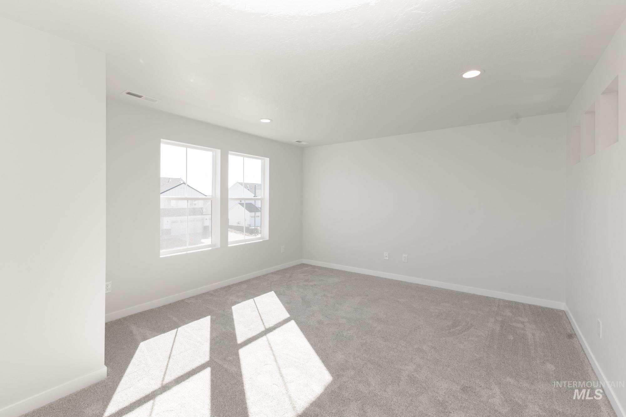 Spare room with carpet and recessed lighting