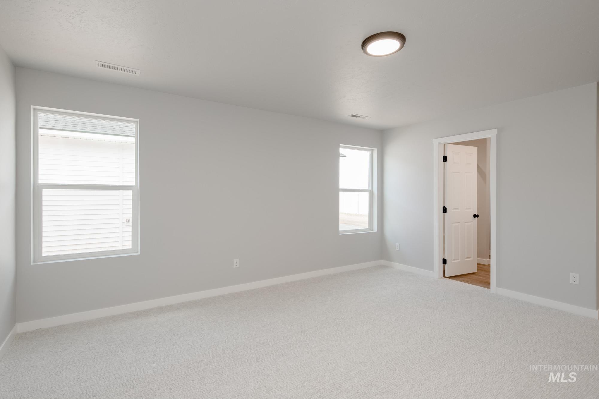 Unfurnished room with light carpet