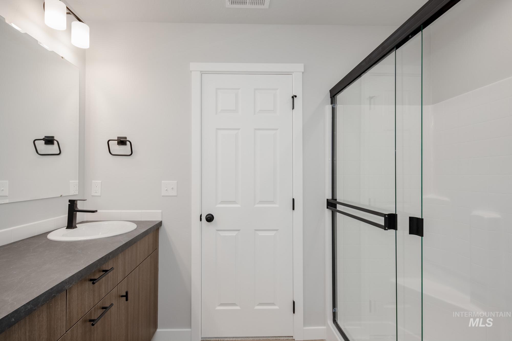 Full bath with vanity and a stall shower