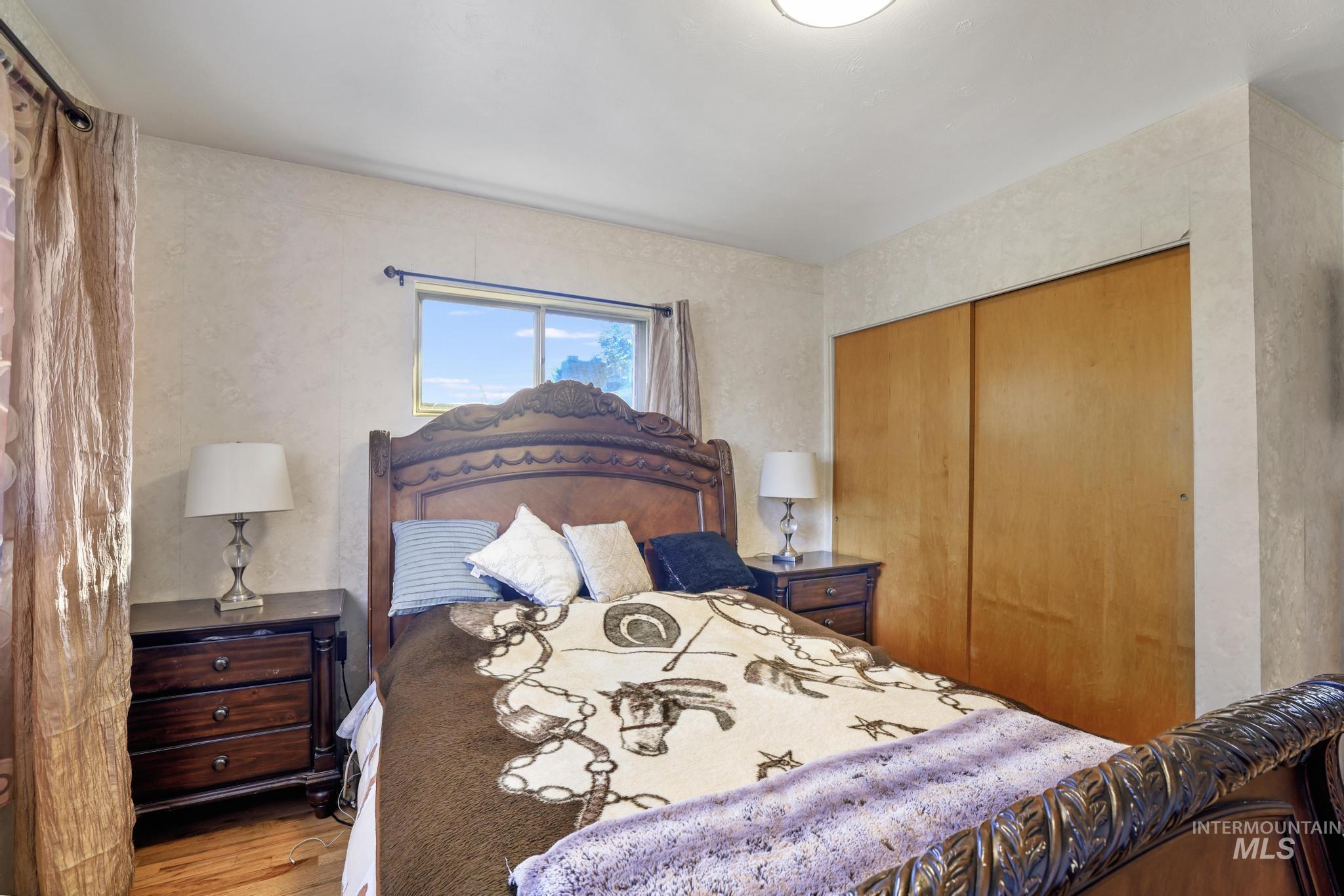 Bedroom with a closet and wood finished floors
